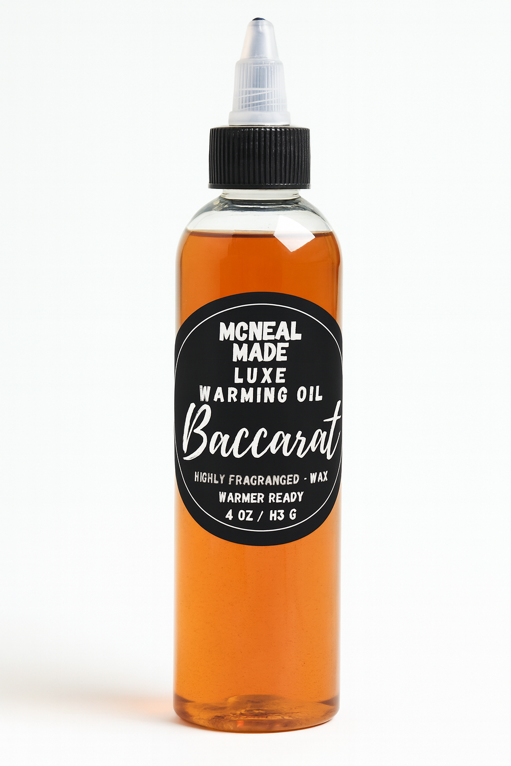Bottle of McNeal Made Luxe Warming Oil Baccarat on a white background